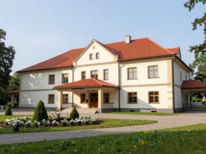 Exterior view of Sanatorium Azalia in Szczawno-Zdrój showing the main building surrounded by greenery