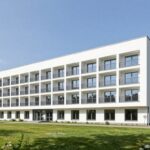 Exterior view of Sanatorium MSWiA Krynica Zdrój showing the main building and surrounding park area